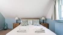 The relaxing blue tones of the bedroom with king-size double bed.