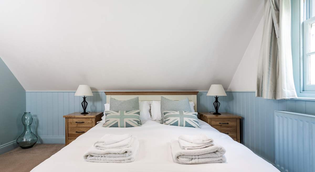 The relaxing blue tones of the bedroom with king-size double bed.