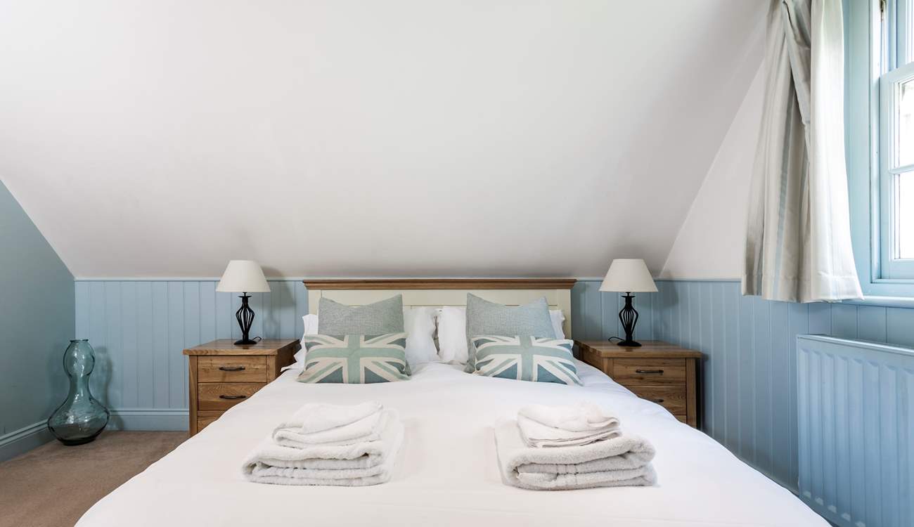 The relaxing blue tones of the bedroom with king-size double bed.