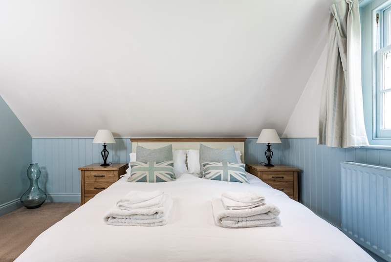 The relaxing blue tones of the bedroom with king-size double bed.