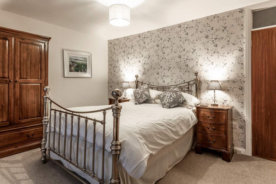 Bedroom 1 has a king-size bed with magnificent sea views.
