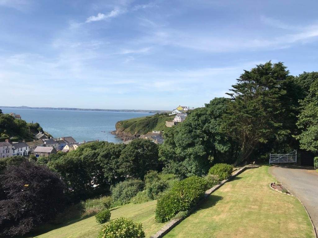 Nestling in a spectacular setting with far reaching coastal views and spacious gardens.