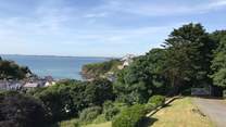 Nestling in a spectacular setting with far reaching coastal views and spacious gardens.