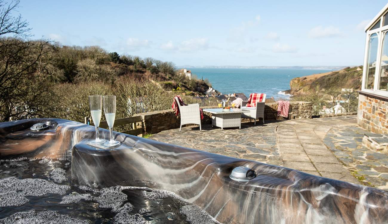 Relax in the idyllic, spacious hot tub taking in the captivating sea views. 
