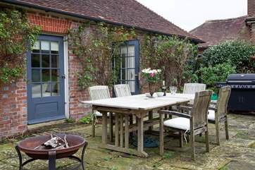 Outdoor seating with fire-pit and barbecue.