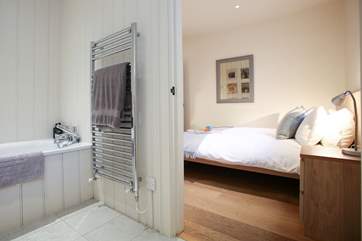 The spacious en suite bathroom has a heated towel rail.
