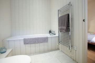 The large en suite with bath and shower attachment.