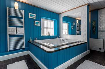 The luxurious spa bath leads to the pool area.