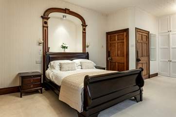 Bedroom 1 with its king-size bed and elegant period features overlooks the square.
