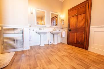 The family bathroom with double wash-basins and a roll-top bath.