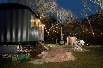 As night falls, pretty festoon lighting illuminates the wonderful outside space.