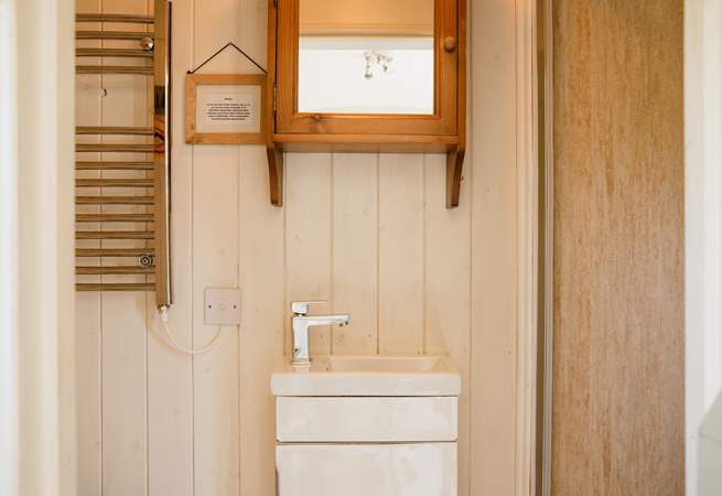 You'll find the light-filled bathroom just beyond the kitchen. 