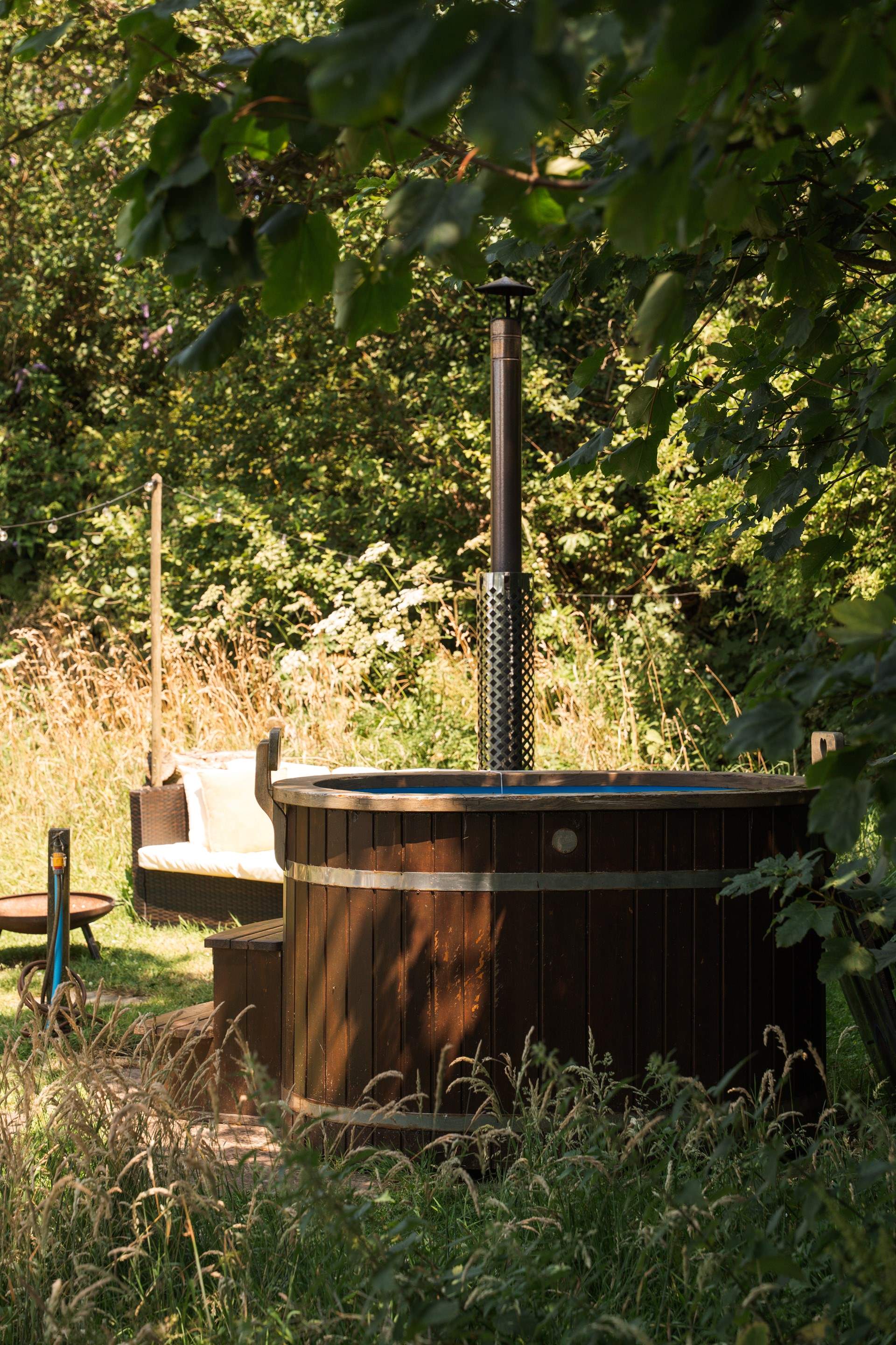 Sink into the wood-fired hot tub wrapped in countryside calm. 