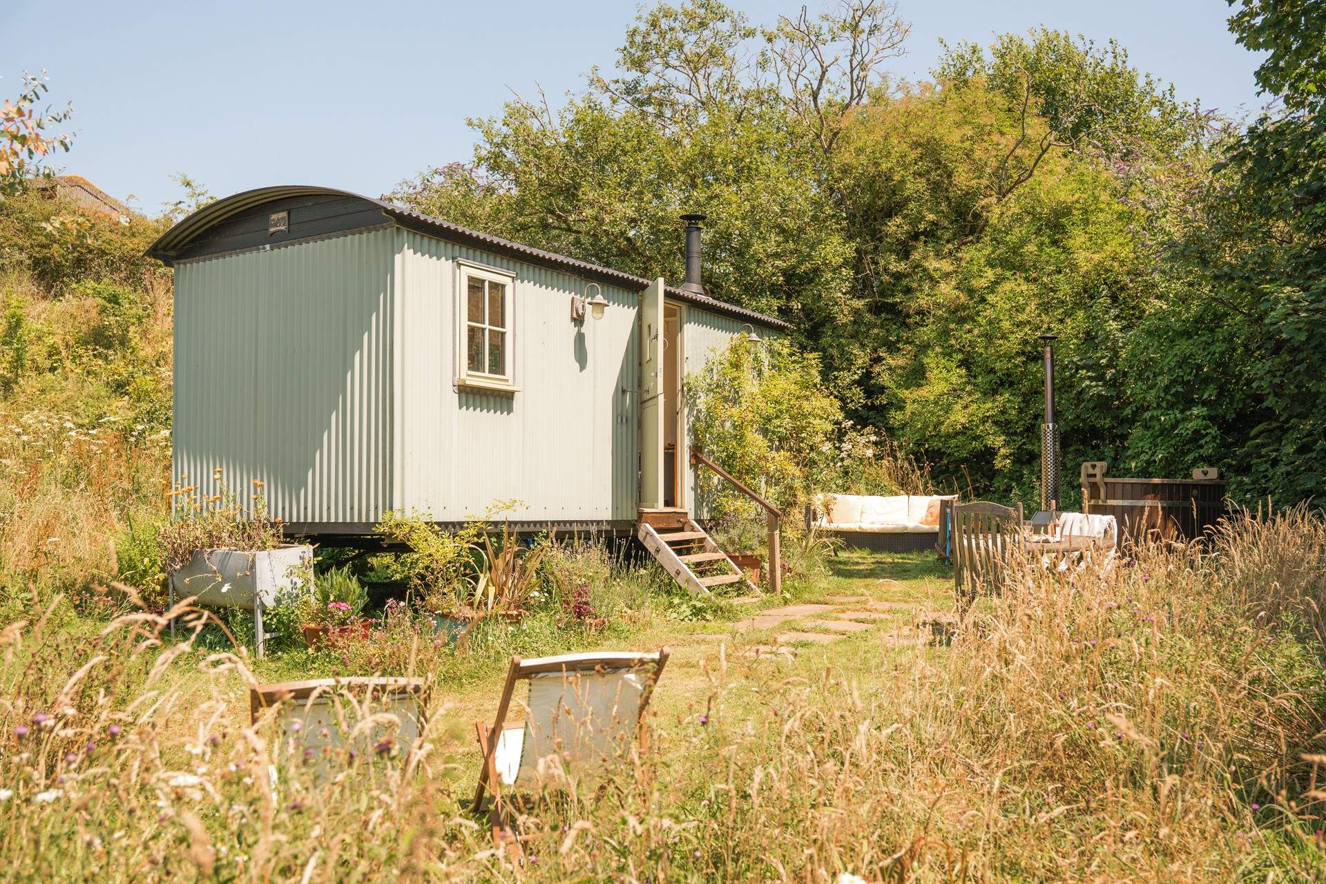 Rosie's Hut - Shepherd’s hut in Devon with a wood-fired hot tub: Appreciate the little things at this rural idyll set in the glorious south Devon countryside. Admire the surrounding wildflowers, stay snuggled inside the wholesome hut or count stars from the secluded wood-fired hot tub.