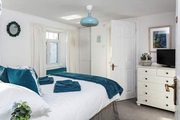 This is the double bedroom, with lovely linens and a window seat to curl up on.