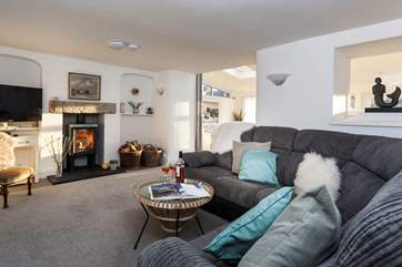 The beautiful sitting-room complete with toasty wood-burner, one step leads through to the conservatory.