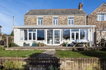 The garden is lovely, and steps lead down from the terrace onto the lawn.