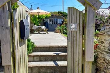 Enter into the sunny terrace garden area from the side gate.