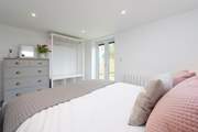 There is plenty of storage in the bedroom and French doors into the garden and to the hot tub.