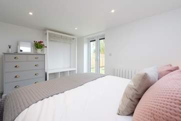 There is plenty of storage in the bedroom and French doors into the garden and to the hot tub.