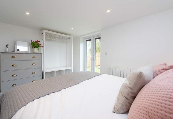 There is plenty of storage in the bedroom and French doors into the garden and to the hot tub.