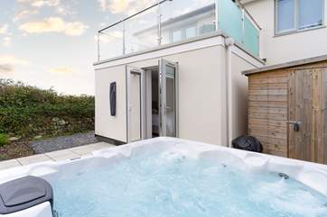 The French doors from Bedroom one open onto the patio with the hot tub.