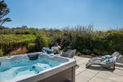 The fabulous hot tub can be found on the secluded ground floor patio.