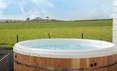 Sink into the hot tub and take in that view! There are 3 steps down from the deck into the garden. - Thumbnail Image