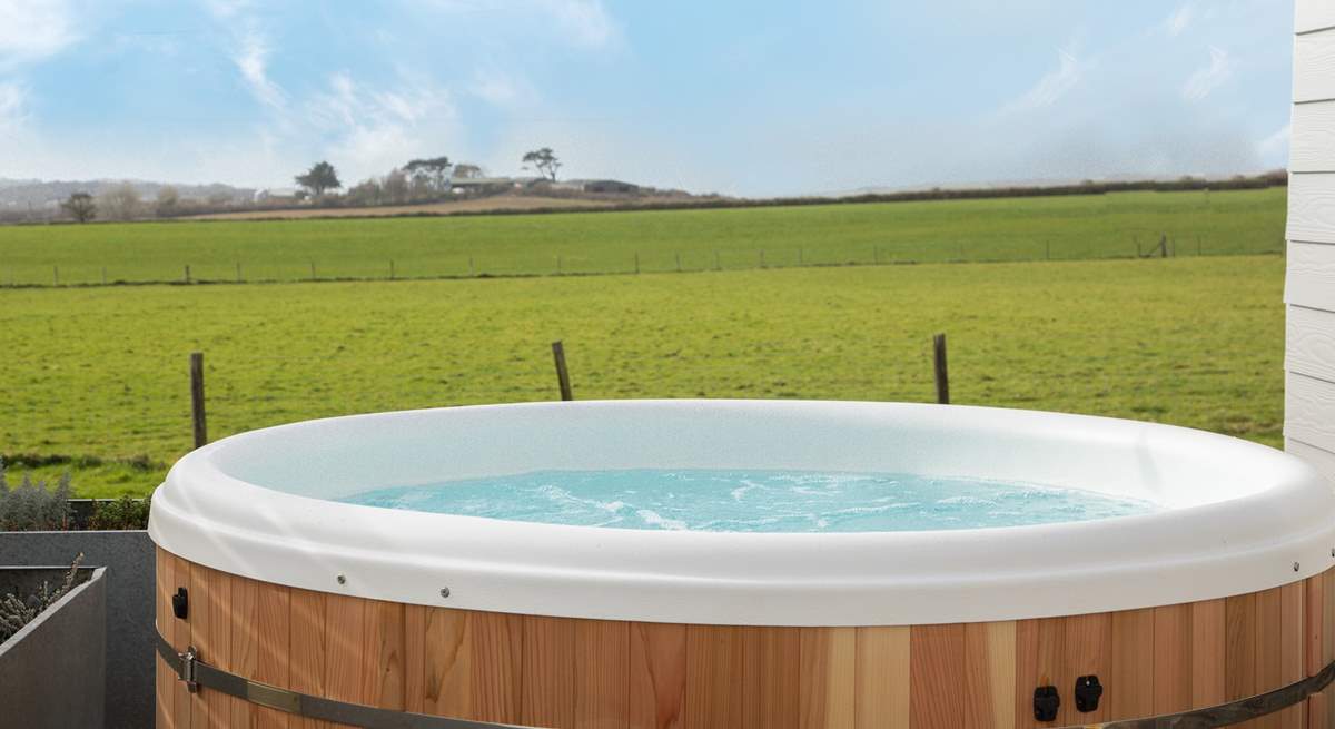 Sink into the hot tub and take in that view! There are 3 steps down from the deck into the garden.