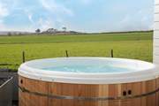 Sink into the hot tub and take in that view! There are 3 steps down from the deck into the garden.