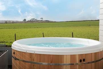 Sink into the hot tub and take in that view! There are 3 steps down from the deck into the garden.