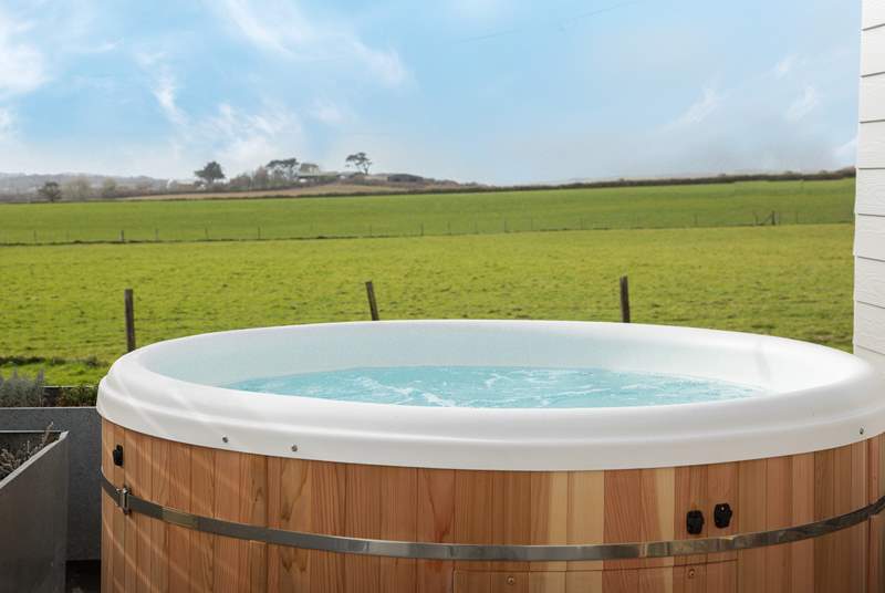 Sink into the hot tub and take in that view! There are 3 steps down from the deck into the garden.