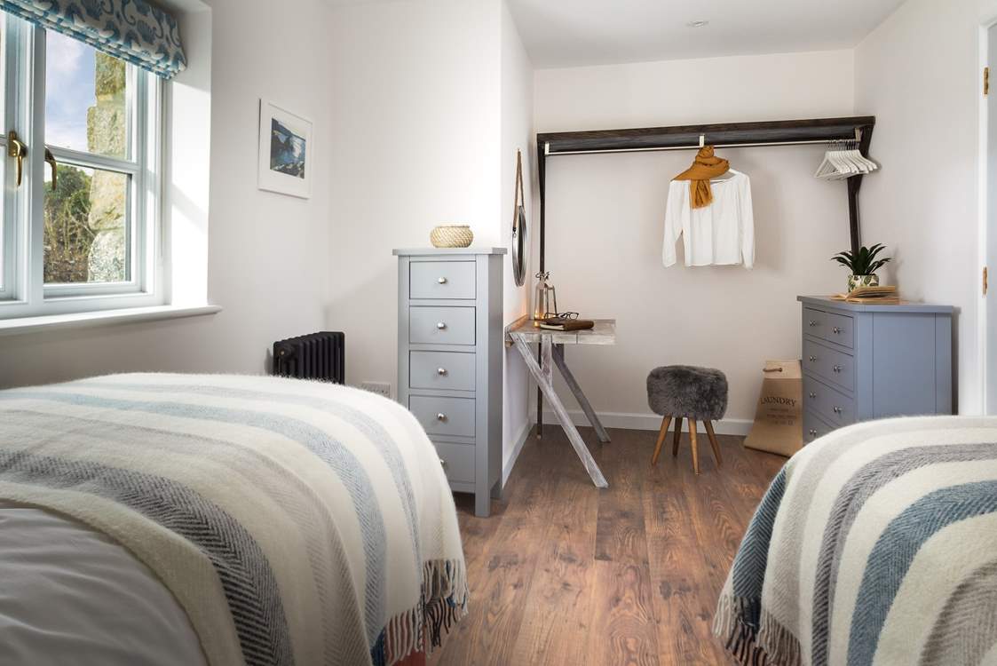 The second bedroom has been cleverly styled to provide space to work in (if you so wish).