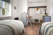 The second bedroom has been cleverly styled to provide space to work in (if you so wish).
