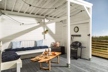 This is one of the areas of outdoor living. It is undercover so rain or shine you can always eat al fresco. There are 3 steps down from the deck to the garden.