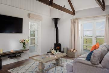 Stargazy has a wonderful sitting-area with doors that lead out onto the decked terrace and garden.