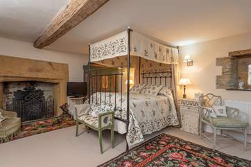 The master bedroom has fabulous original features, as well as a very grand four-poster bed.