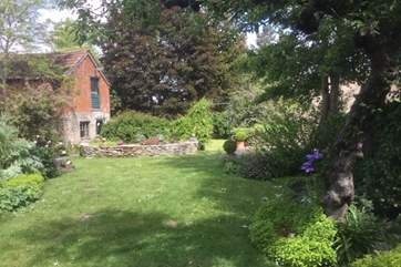 The view down the garden from the sun-trap of a patio.