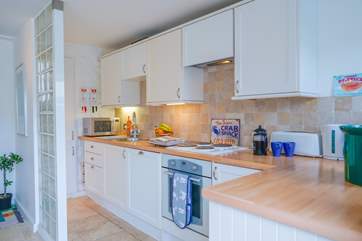 A functional galley-style kitchen with well stocked cupboards and that all important dishwasher.