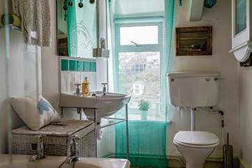 The bathroom offers an electric shower over the bath and is functional and unique in its styling.