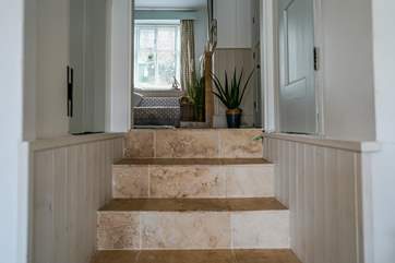 Stepping down from the sitting-room you walk through the kitchen/diner to the three tiered terrace and direct access to the estuary,