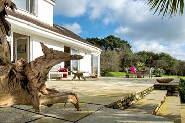 The steps from the garden path lead to a large terrace outside the house.