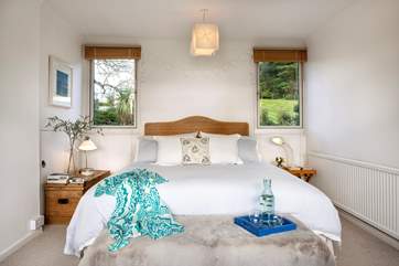 The master bedroom on the first floor has a fabulous super-king bed and glorious views over the creek.