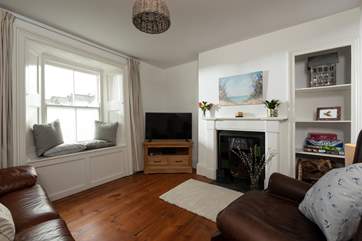 The cosy sitting-room enjoys a very sunny aspect. (An electric stove was installed in November 2020).