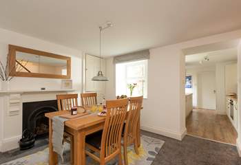 The dining-area is a lovely space to enjoy breakfast together. A small step takes you down into the kitchen area. 