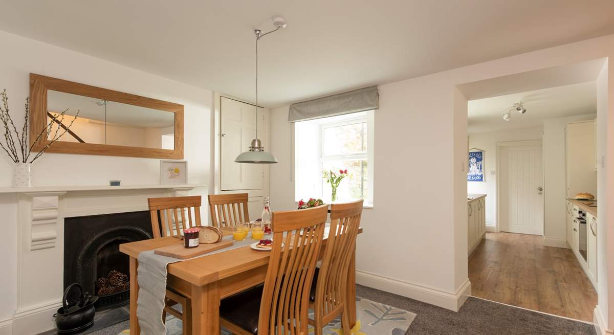 The dining-area is a lovely space to enjoy breakfast together. A small step takes you down into the kitchen area. 