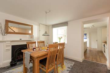 The dining-area is a lovely space to enjoy breakfast together. A small step takes you down into the kitchen area.