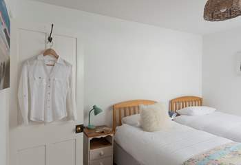 A wooden step leads up from the small landing into the pretty twin bedroom. 