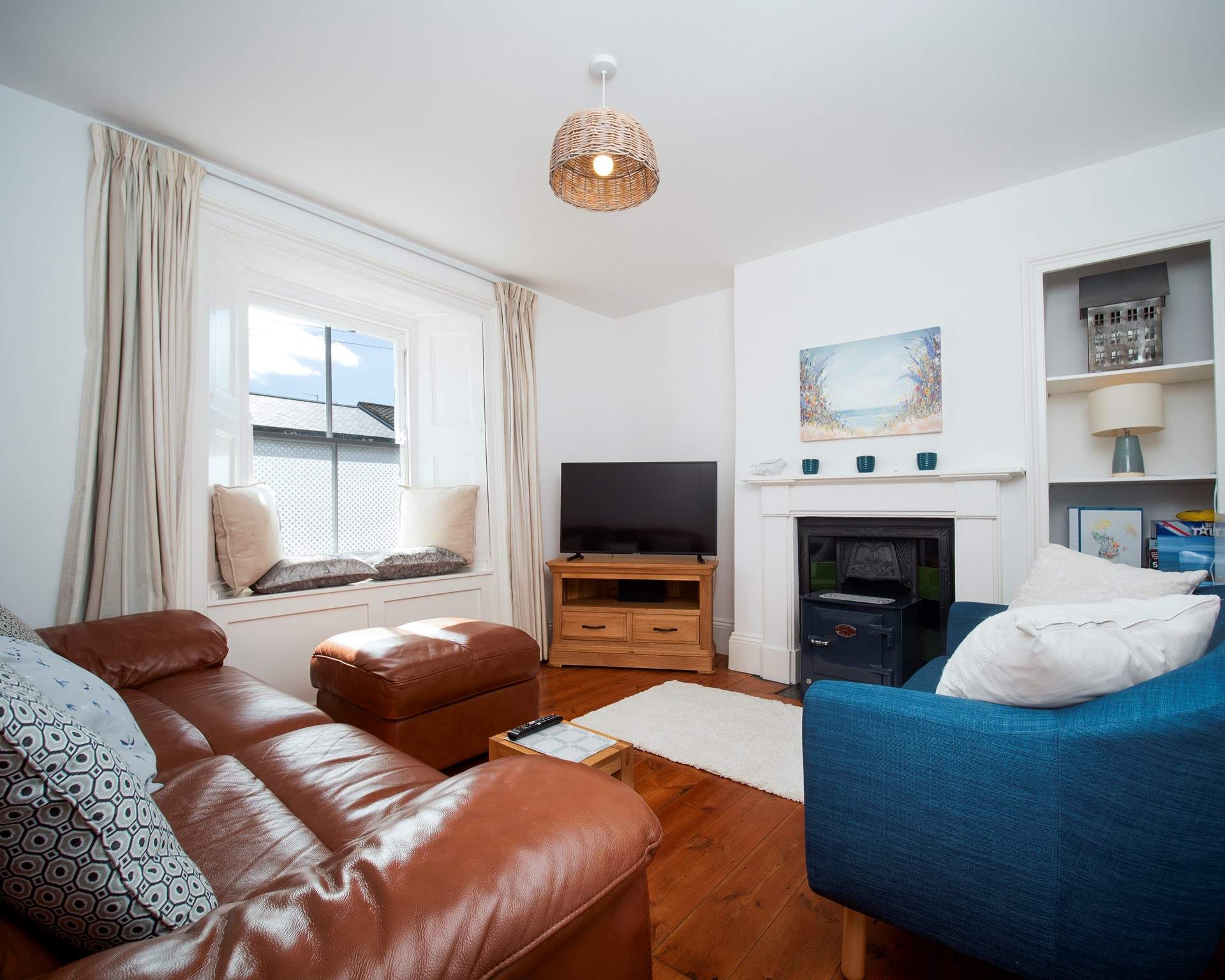 The lovely cosy sitting-room -(the wood burner has been removed and now a decorative fireplace).