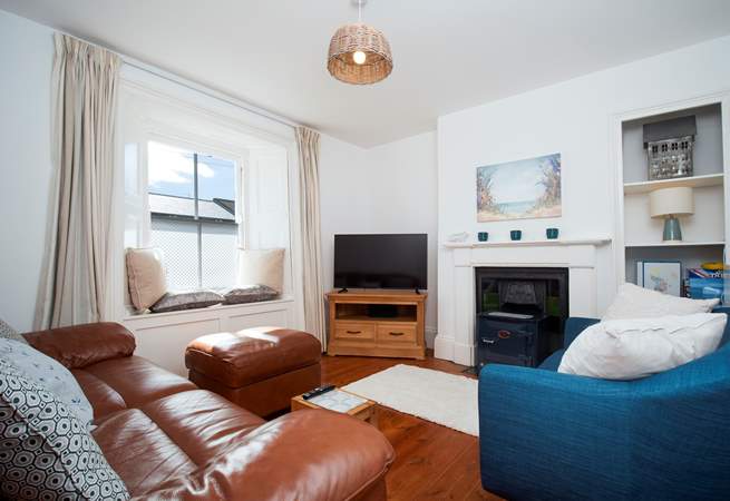 The lovely cosy sitting-room -(the wood burner has been removed and now a decorative fireplace).